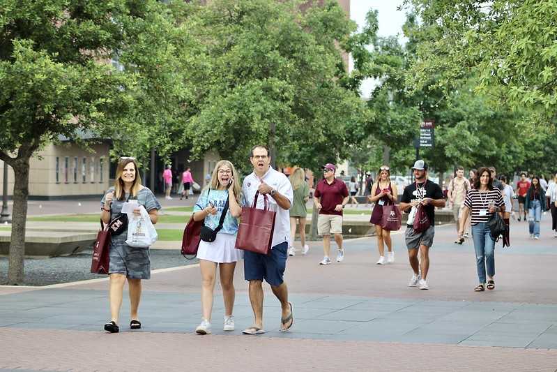 Parents and a student walking through Kyle Field Plaza during their NSC
